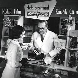 Photograph - Kodak Australasia Pty Ltd, Man Serving Woman in Shop, Sydney, New South Wales, circa 1950s