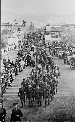 Procession of un-armed men in military uniform.