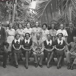 Group portrait of Kodak staff in tropical garden.