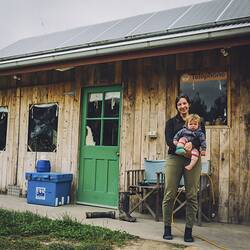 Digital Photograph - Amelia Bright Holding Daughter Hazel in Front of Home, Fish Creek, Victoria, 24 October 2016