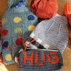 Crocheted hot water bottle covers and yarn.