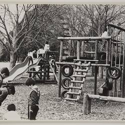 Children using play equipment in an adventure playground.