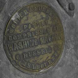 Metal plaque with inscription on a washing machine.