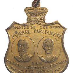 Shield shaped medal with portrait busts of Duke and Duchess of Cornwall and York.