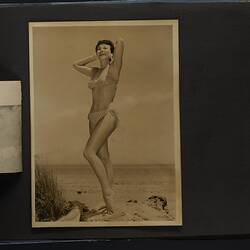 Album page, photograph, black and white, woman posing in polka dot bikini, standing.