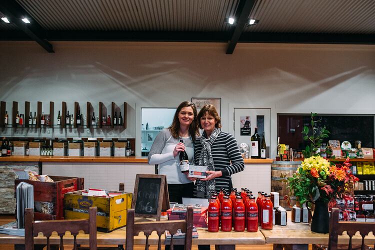 Two women in a food and wine store.