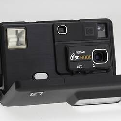 Black plastic camera with opened front panel.