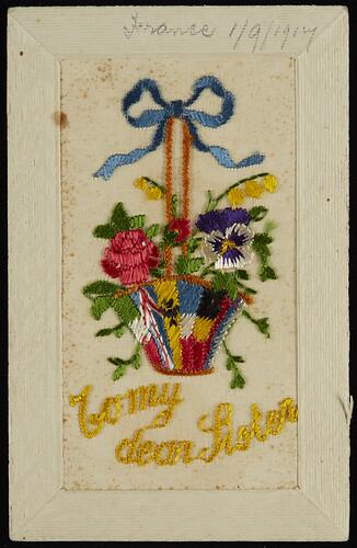 Front of postcard with floral embroidery.