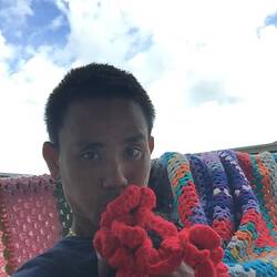 Digital Photograph -  Aung Saw Lim (Man Man) with Crochet Poppies & Quilt, Manus Island, circa 2017