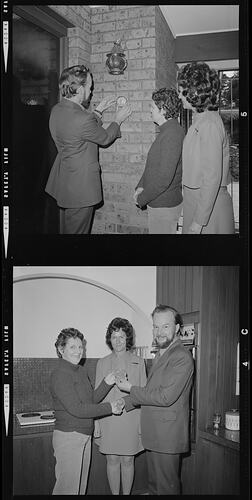 Two images. Top man places medal on internal brick wall as two women watch. Bottom same group in kitchen.