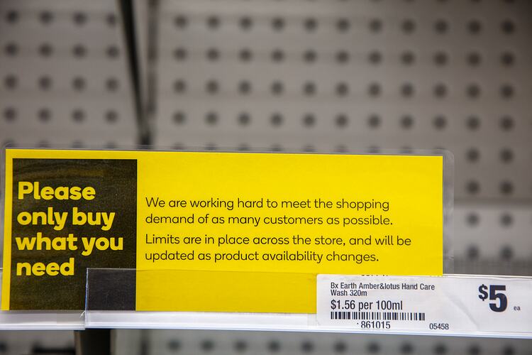Yellow information poster sign with printed text attached to empty shelf.