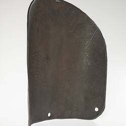 Curved brown section of metal with small punched holes at lower end.