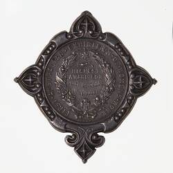 Medal with central wreath topped by Commonwealth Star and closed with the Southern Cross.