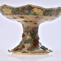 Cream coloured compote with wavy edges decorated with birds & chrysanthemums.