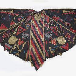 Black leather cape with colourful leather scales and motifs such as hearts, thistles, heraldic shields.