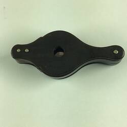 Black loupe, closed. Two round hinged magnifying glasses have be slid into the case.