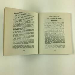 Open booklet, white pages with black printed text.