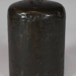 Cylindrical weight with loop at top.