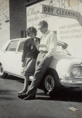 Digital Photograph - Man Smoking Pipe with Woman, in front of Car, Fitzroy, 1963