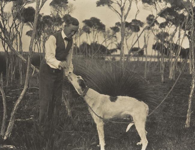 Digital Photograph - Charles Nuttall Feeding 'Kangaroo' Dog, Saint Margaret Island, 1910-1920