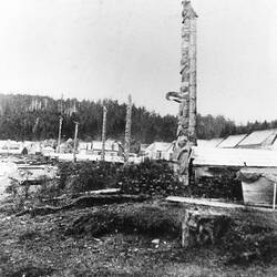 Grainy photograph of totem poles.