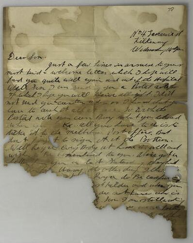 Handwritten letter on buff coloured paper, badly water damaged and torn. Text is cursive in black ink.