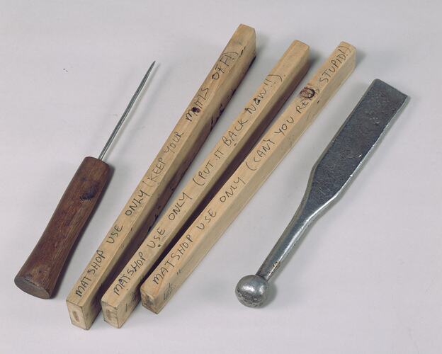Tools used for mat making including; loom hammer, thread holder and mat measuring blocks.