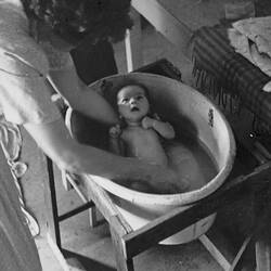Woman Giving Baby First Bath at Home, Nunawading, 1951