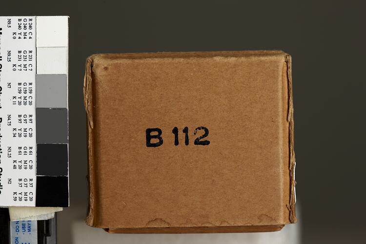 Brown cardboard box, black text, for paper tape.