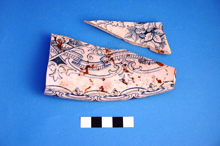 Two fragments from a chamber pot with blue transfer print.