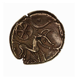 Coin, round, crude horse with branched tail to right; above, wheel & crescent; below, top of wheel.