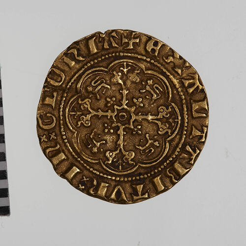Coin, round, a floriated cross. In each angle, a Lion passant facing left. Text around.