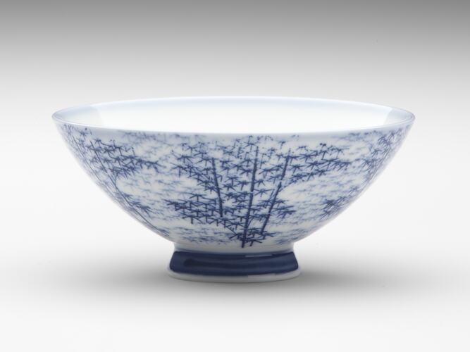 White ceramic rice bowl with blue detail.
