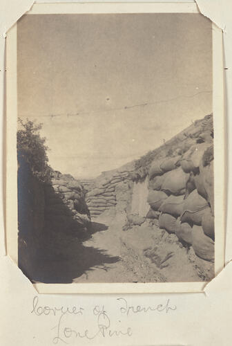 Trench with sandbags lining left and right sides.