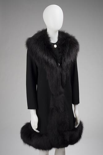 Black coat, black fur around shoulders and hem.