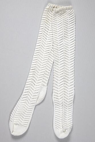 Long, white socks featuring a lacy chevron pattern.