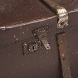 Brown hard leather suitcase detail. Rusted metal lock.