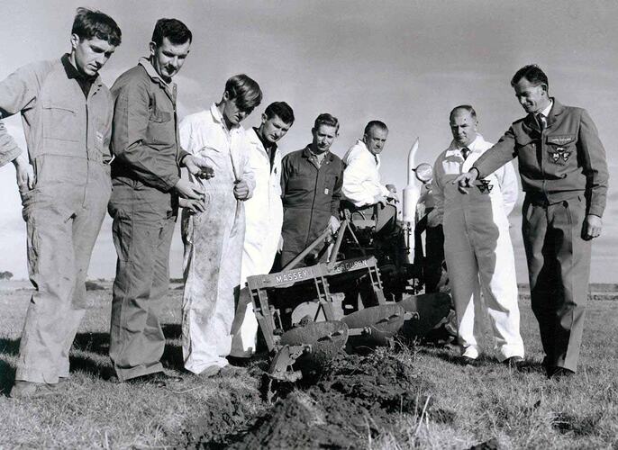 Group of men around Massey Ferguson 66 mouldboard plough.