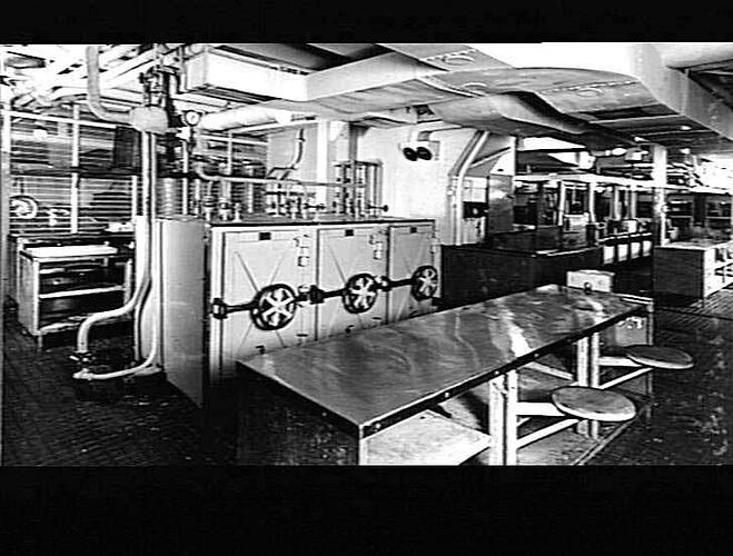 Ship interior. Main kitchen galley. Metal benchtops with fixed stools.