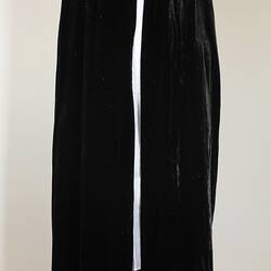 Black ankle length cloak on white mannequin.