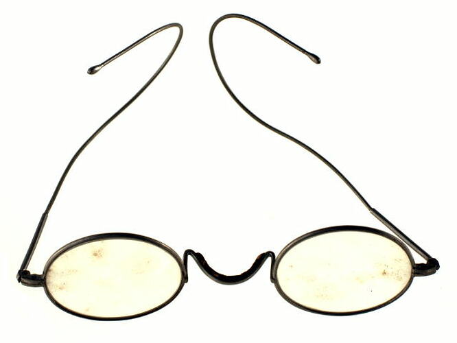 Steel rimmed spectacles or eye glasses with oval lenses.
