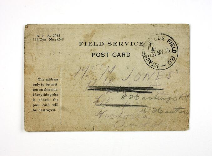 Stamp marked postcard with printed and written text.