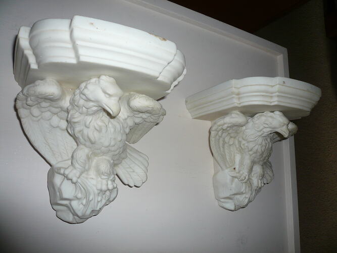 Photograph of a pair of alabaster mantlepiece corbels in the form of eagles.