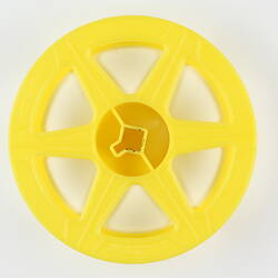 Circular plastic film reel with six spokes.