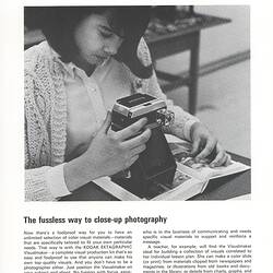 Article with photograph of woman using photographic apparatus.