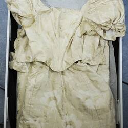 Cream dress showing upper bodice detail.