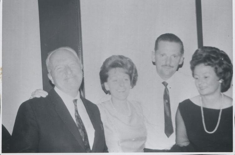 Two men and two women smiling.