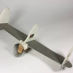 Tail section of model aeroplane. Painted silver and white featuring Australian flag.