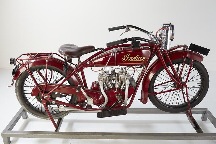 Red motor cycle, right profile.