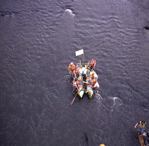 Aerial view of people on river raft.